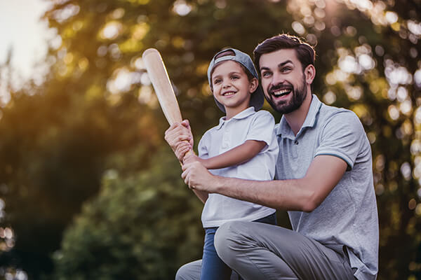 Father playing baseball with son